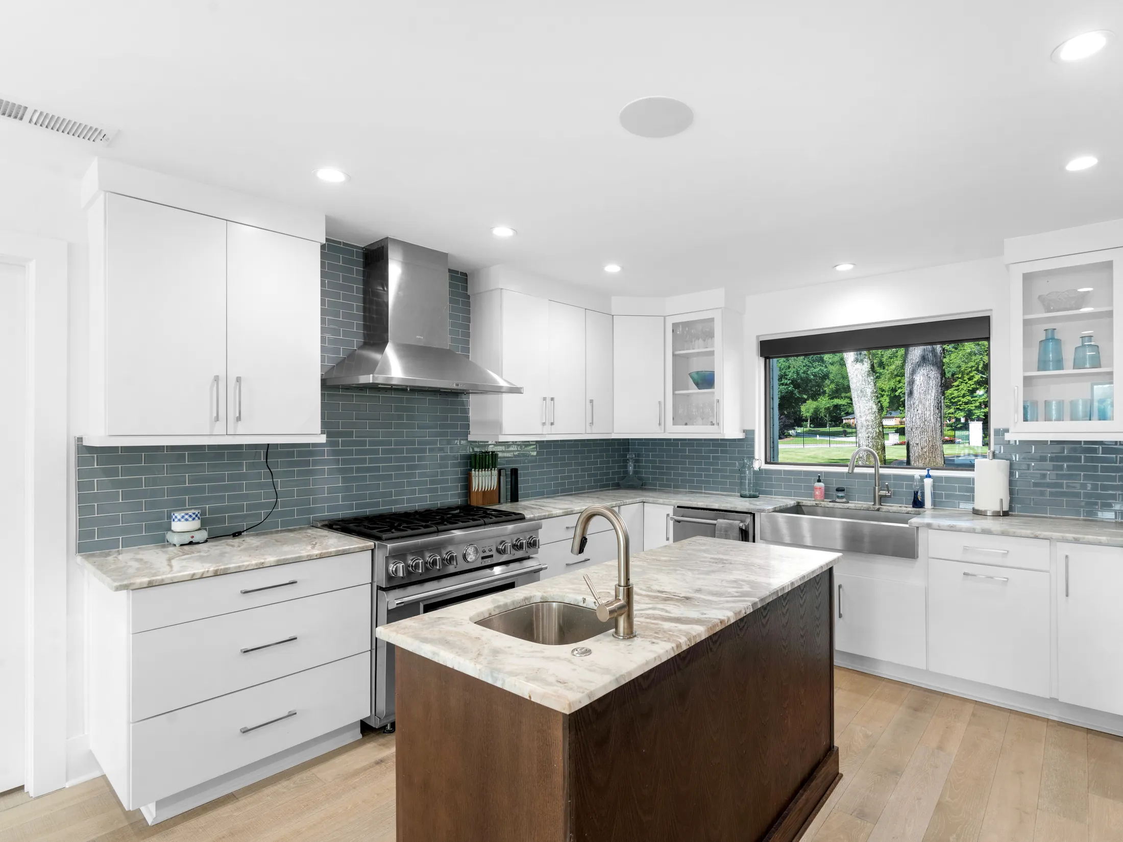 Remodeled kitchen with a large island by Summit Design Build